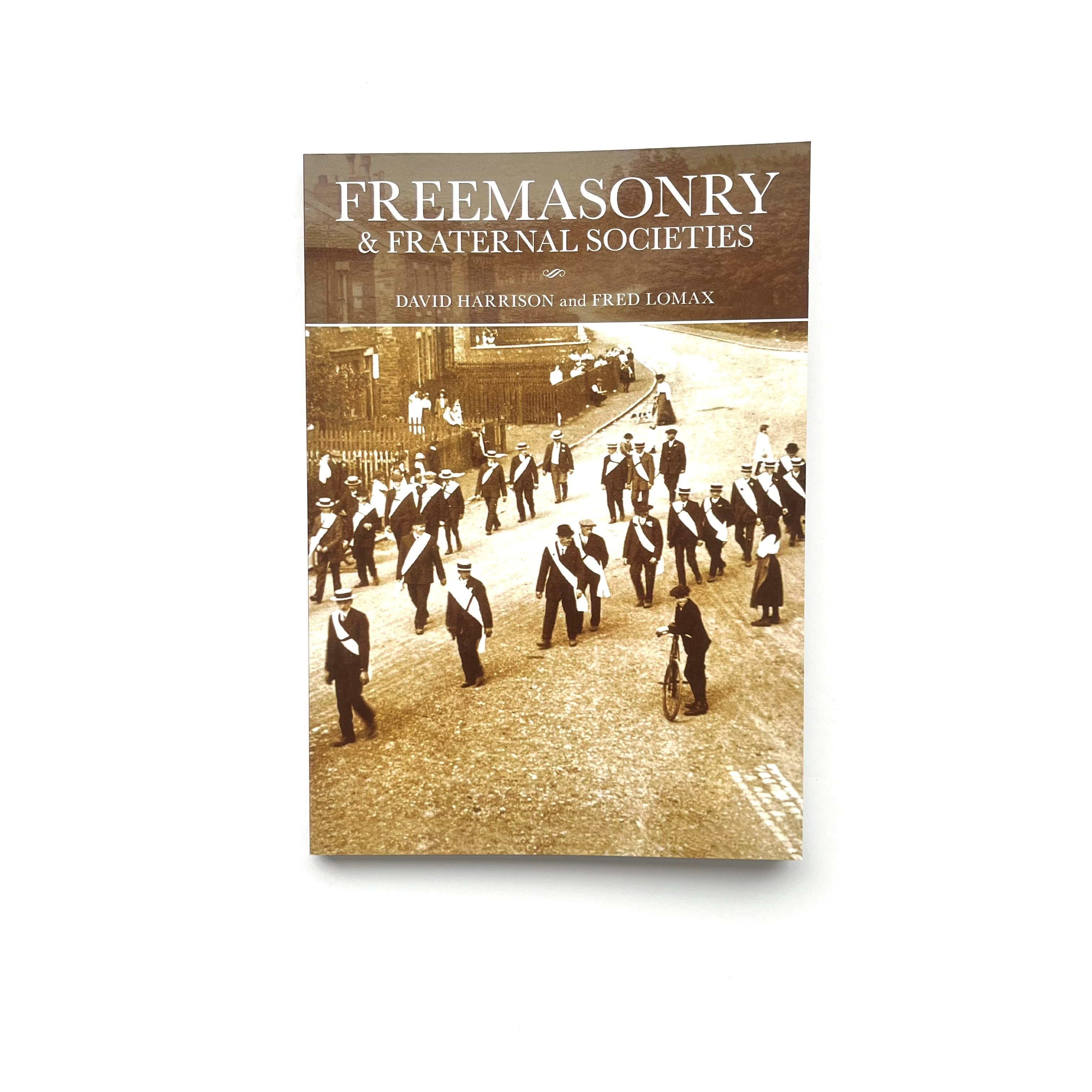 The cover of the book 'Freemasonry and Fraternal Societies' shows a black and white photograph of a group of men in formal attire marching down a street.