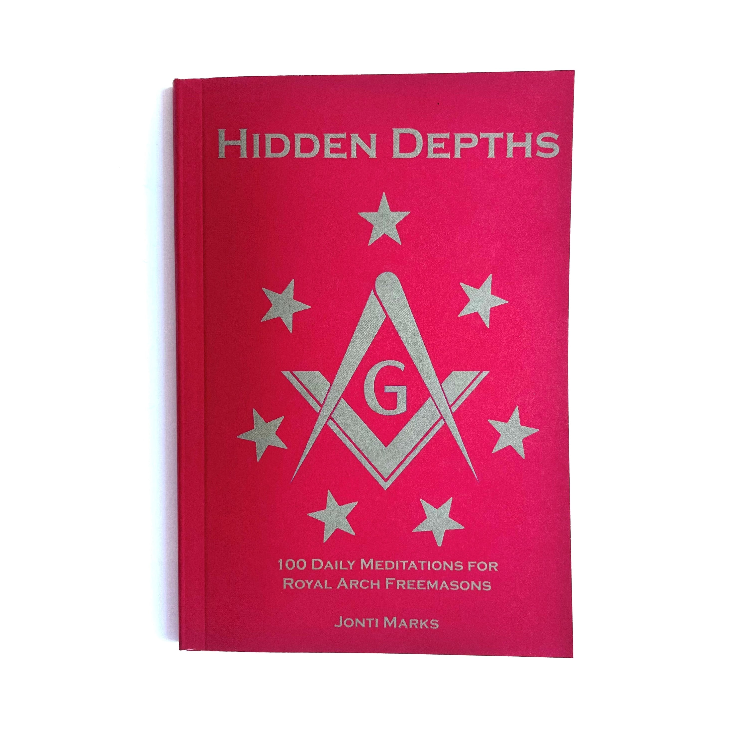 A pink book titled 'Hidden Depths' with Masonic symbols and stars printed on the cover. 100 daily meditations for Royal Arch Freemasons. Jonti Marks