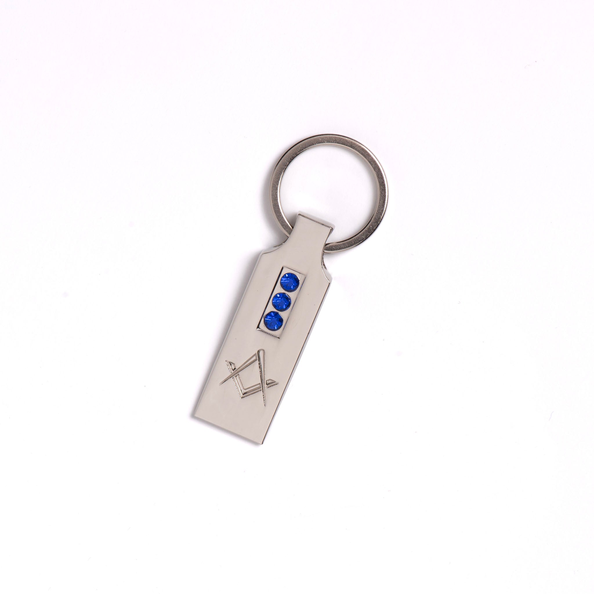 A silver-coloured keyring with a Masonic square and compasses design, embellished with blue style crystals.