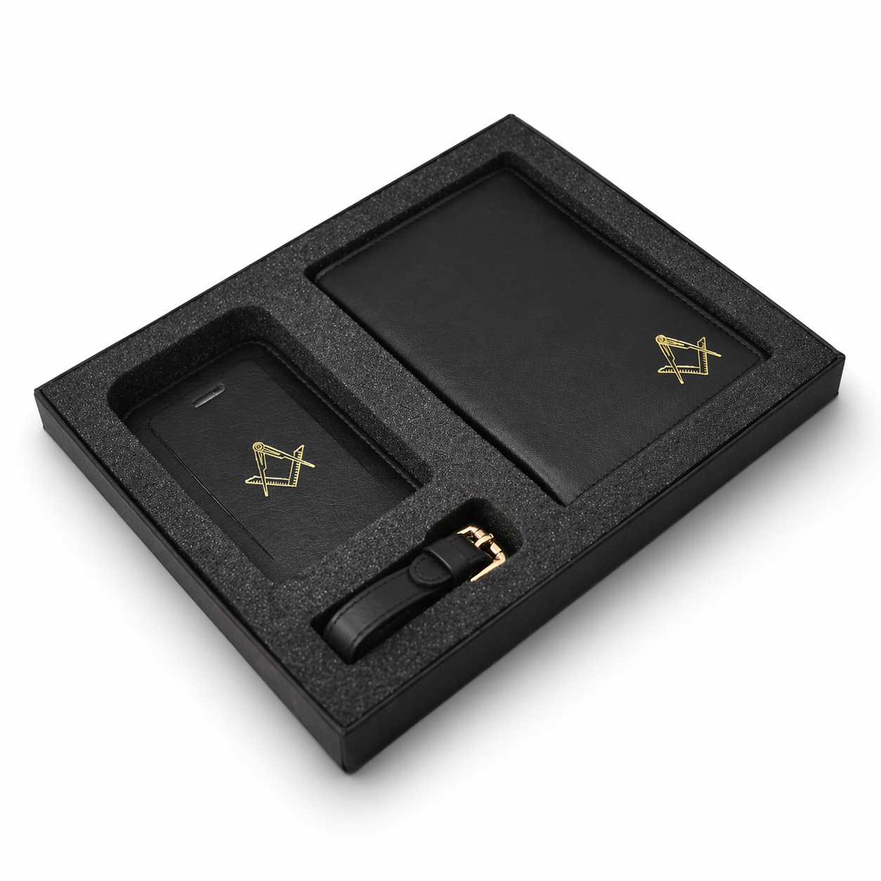 Side view of black leather gift set in a presentation box, including a passport holder, travel wallet and a luggage tag, each featuring a gold Masonic square-and-compass emblem.