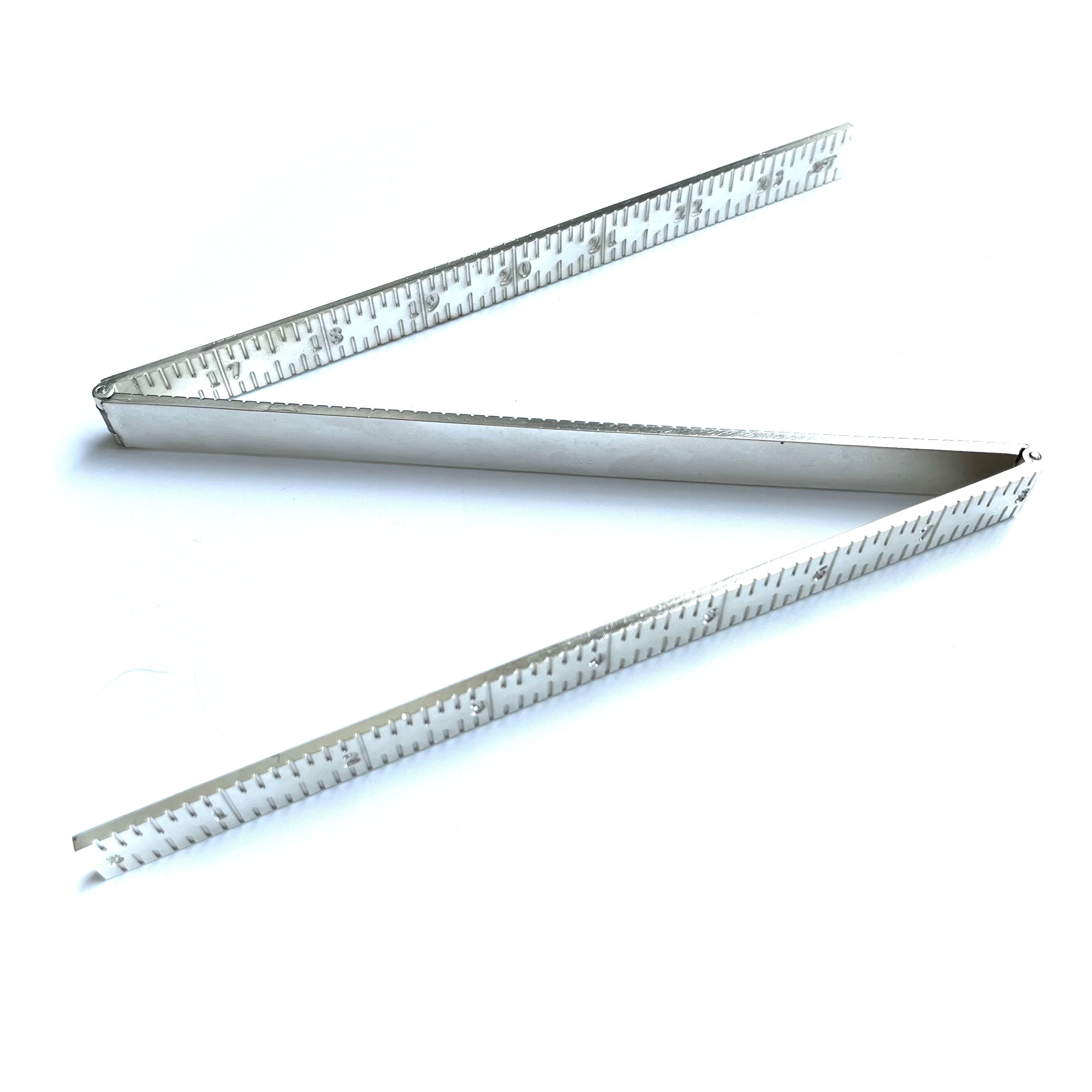 Masonic folding metal rulers on a white background