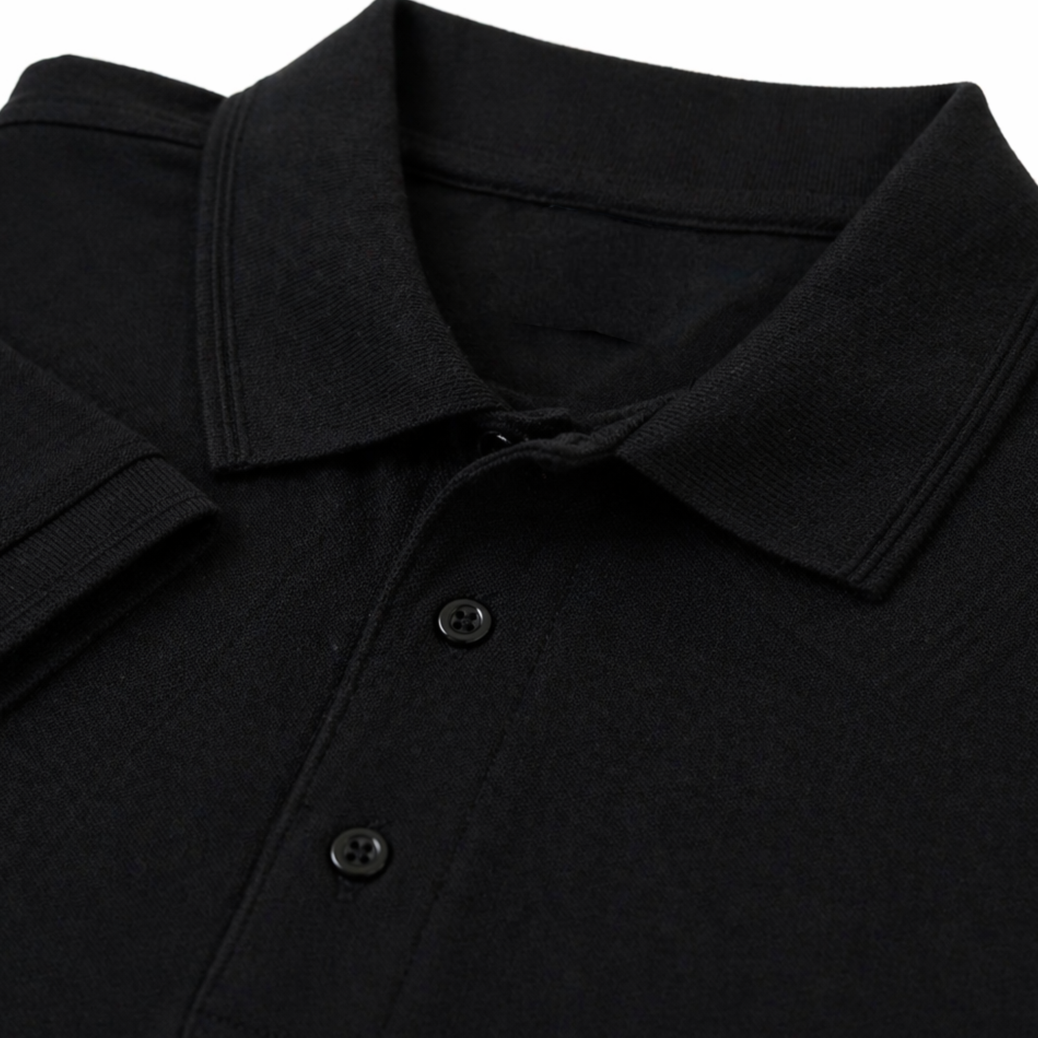 Close up view of olded black polo shirt with a collar and button placket.