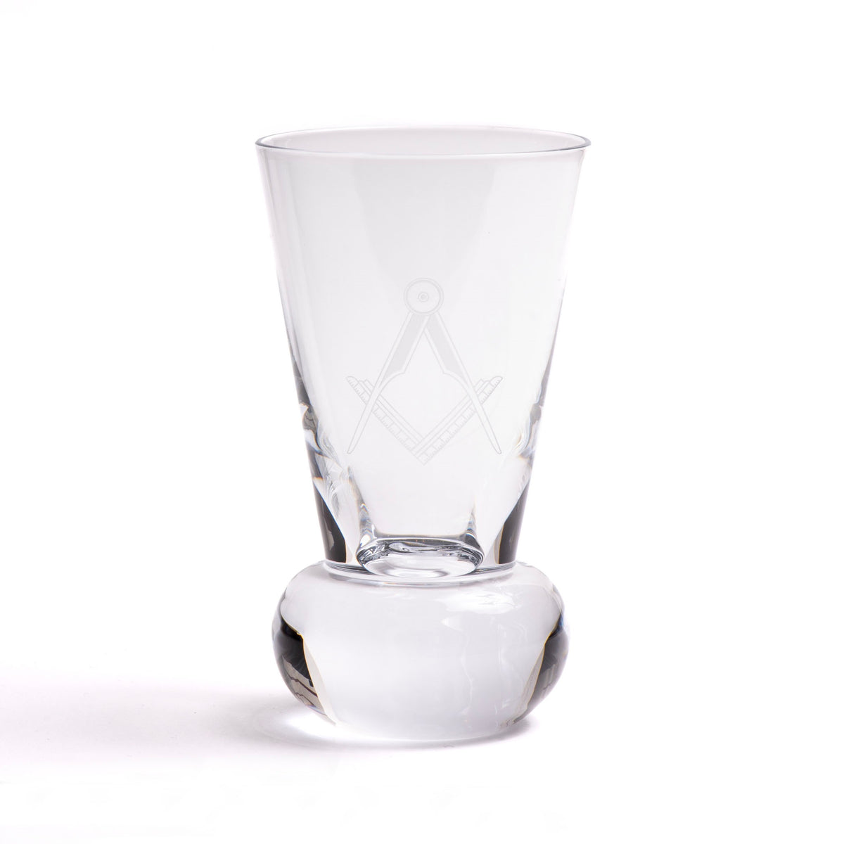 A clear glass with an engraved Masonic square and compasses symbol on the side, standing on a rounded base.