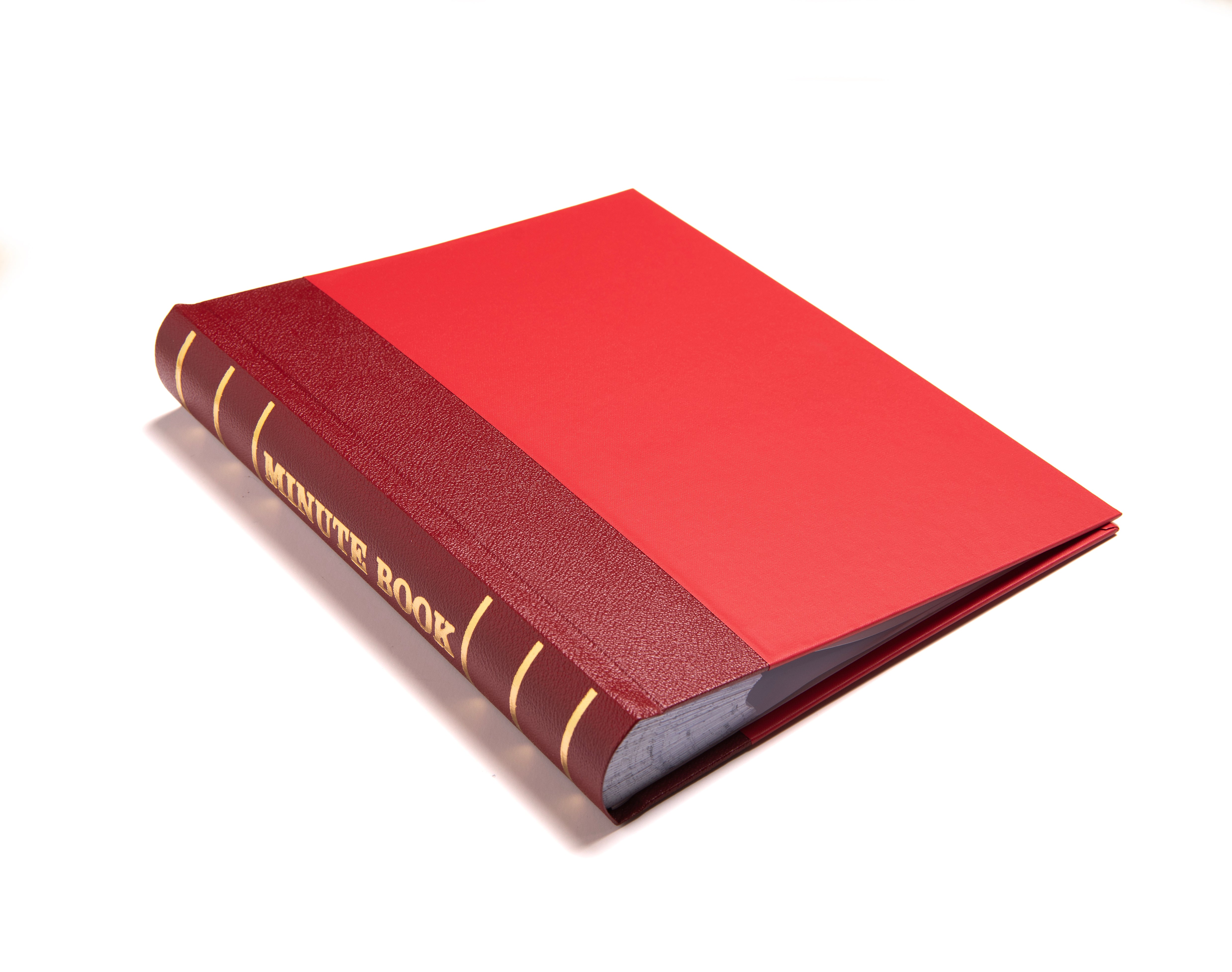 A closed Masonic minute book with a red hardcover, titled 'MINUTE BOOK' on the spine.