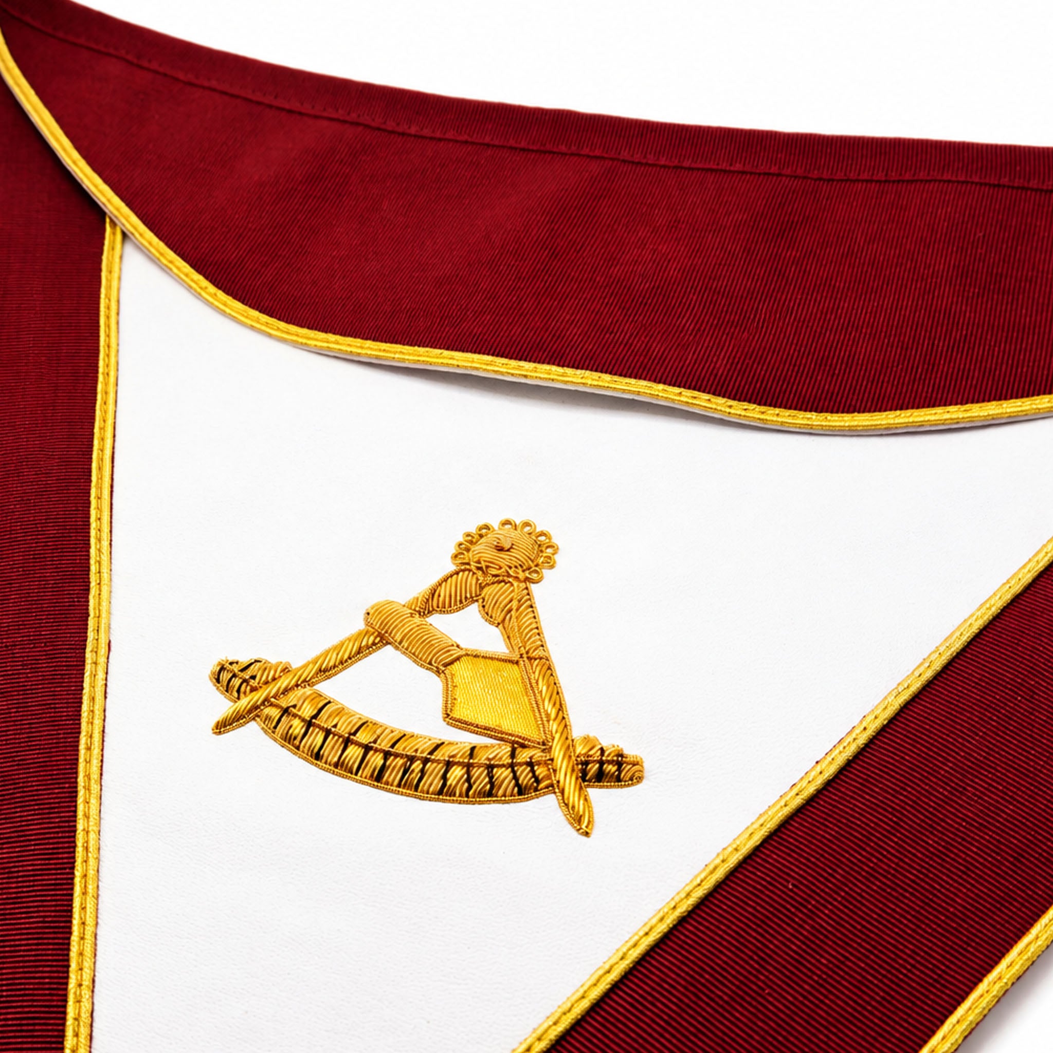 Past Thrice Illustrious Masters Masonic apron with burgundy trim and gold embroidered emblem close up view