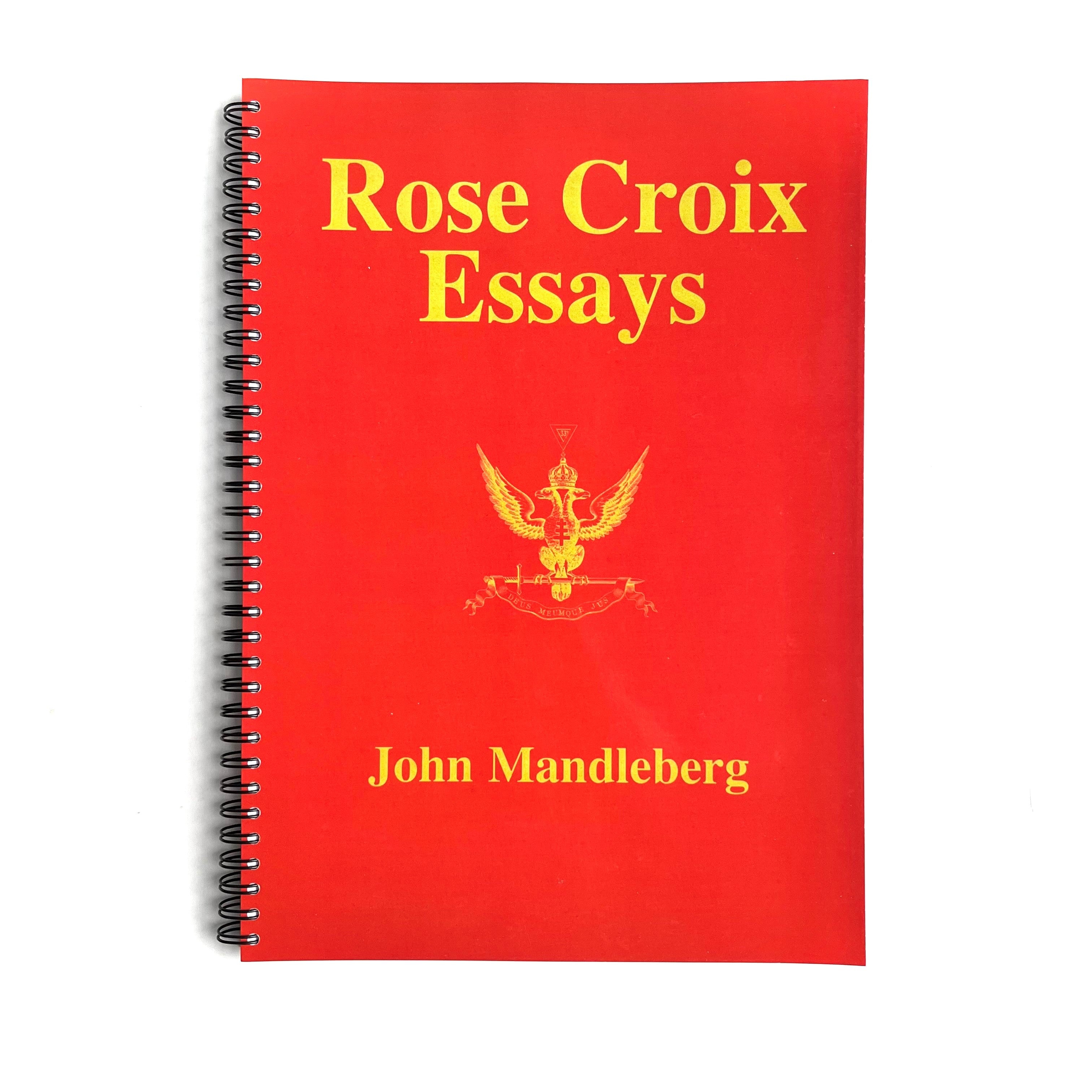 A red book with the title 'Rose Croix Essays' and the author's name 'John Mandleberg' printed on the cover, featuring an embossed emblem.