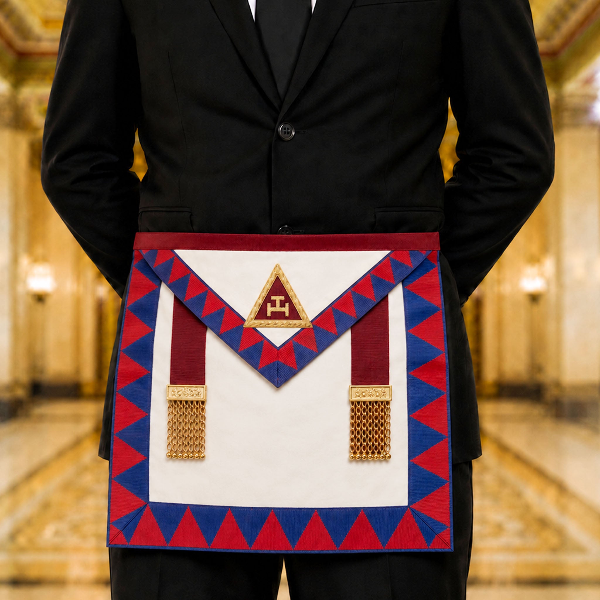 UGLE-approved Masonic Royal Arch Principal apron featuring a white and red front with a gold emblem, red and blue geometric patterns on the sides being worn.