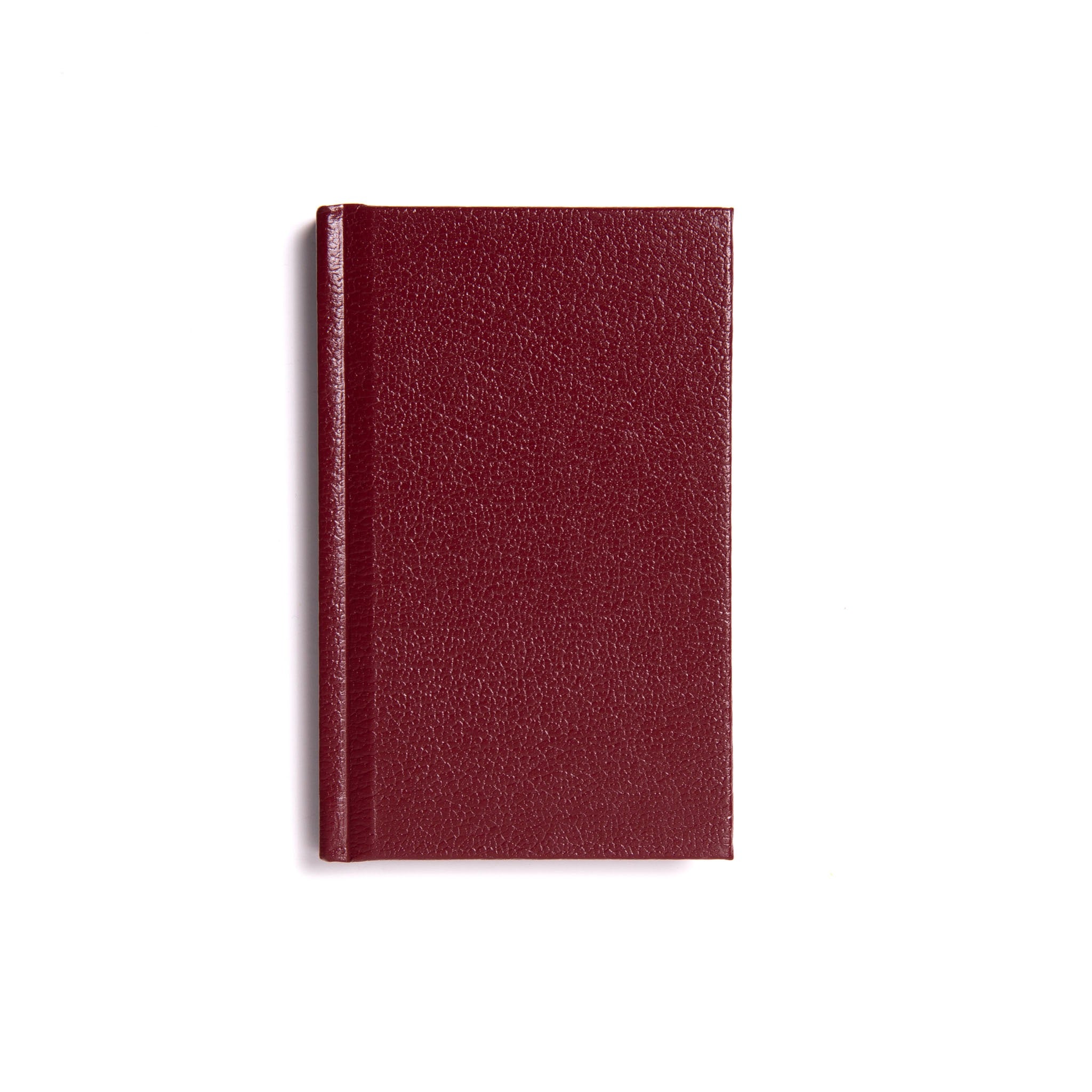 A closed maroon-colored Masonic Taylor's Lectures Ritual book with a smooth cover.