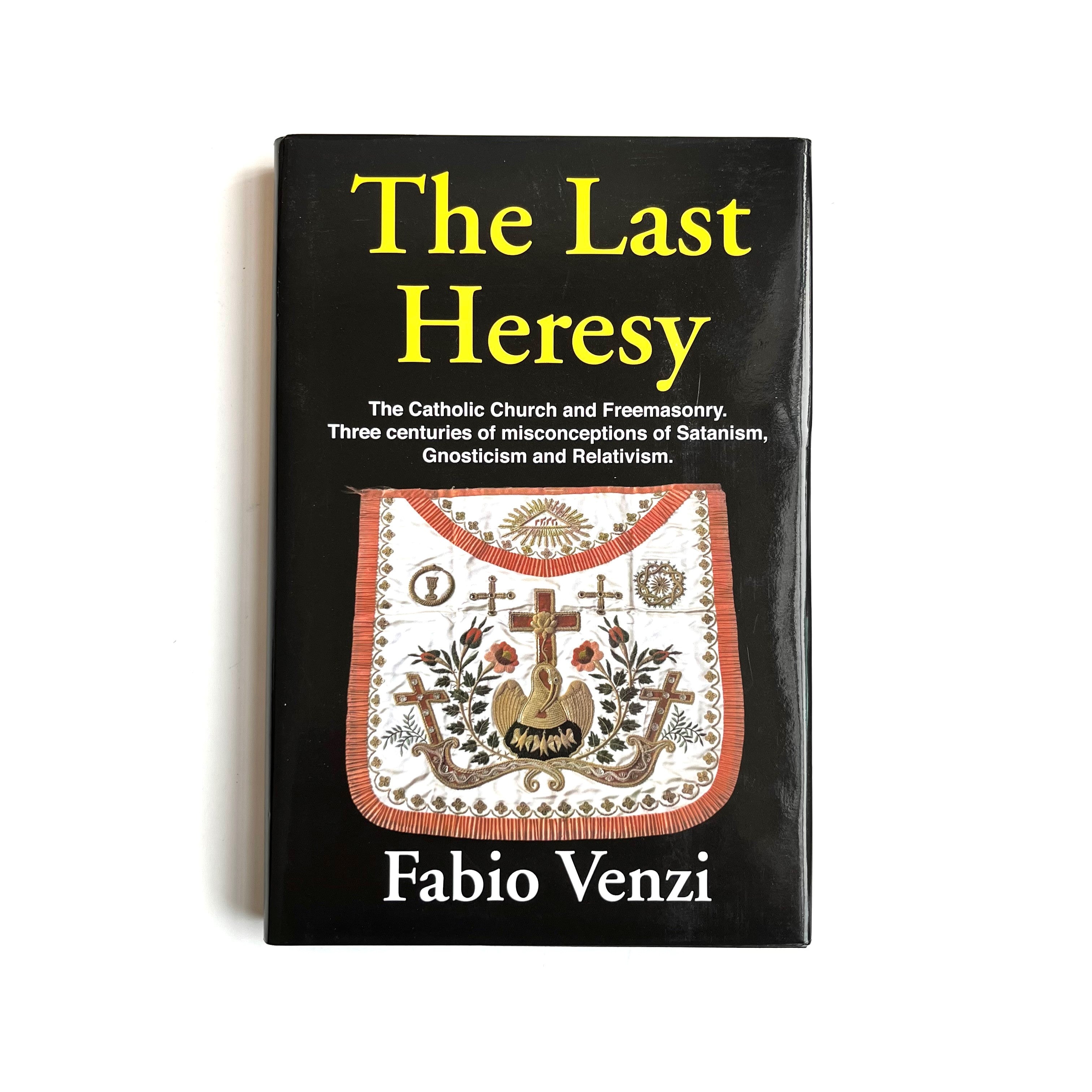 The cover of the book 'The Last Heresy' by Fabio Venzini features a design with a cross and a decorative pattern in colors predominantly yellow, black, and red.