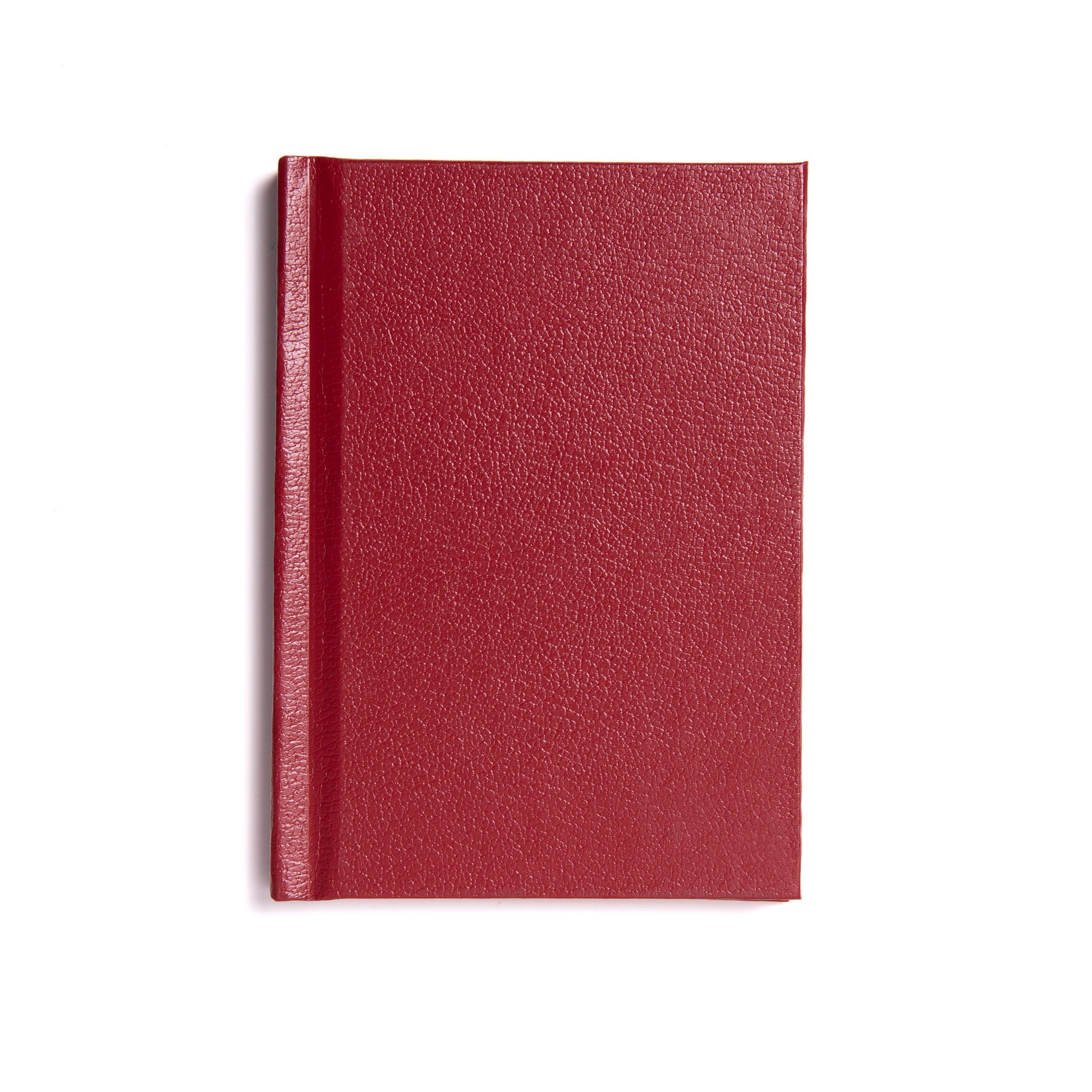 A red hardback book with a visible spine and a smooth cover, placed on a white background.