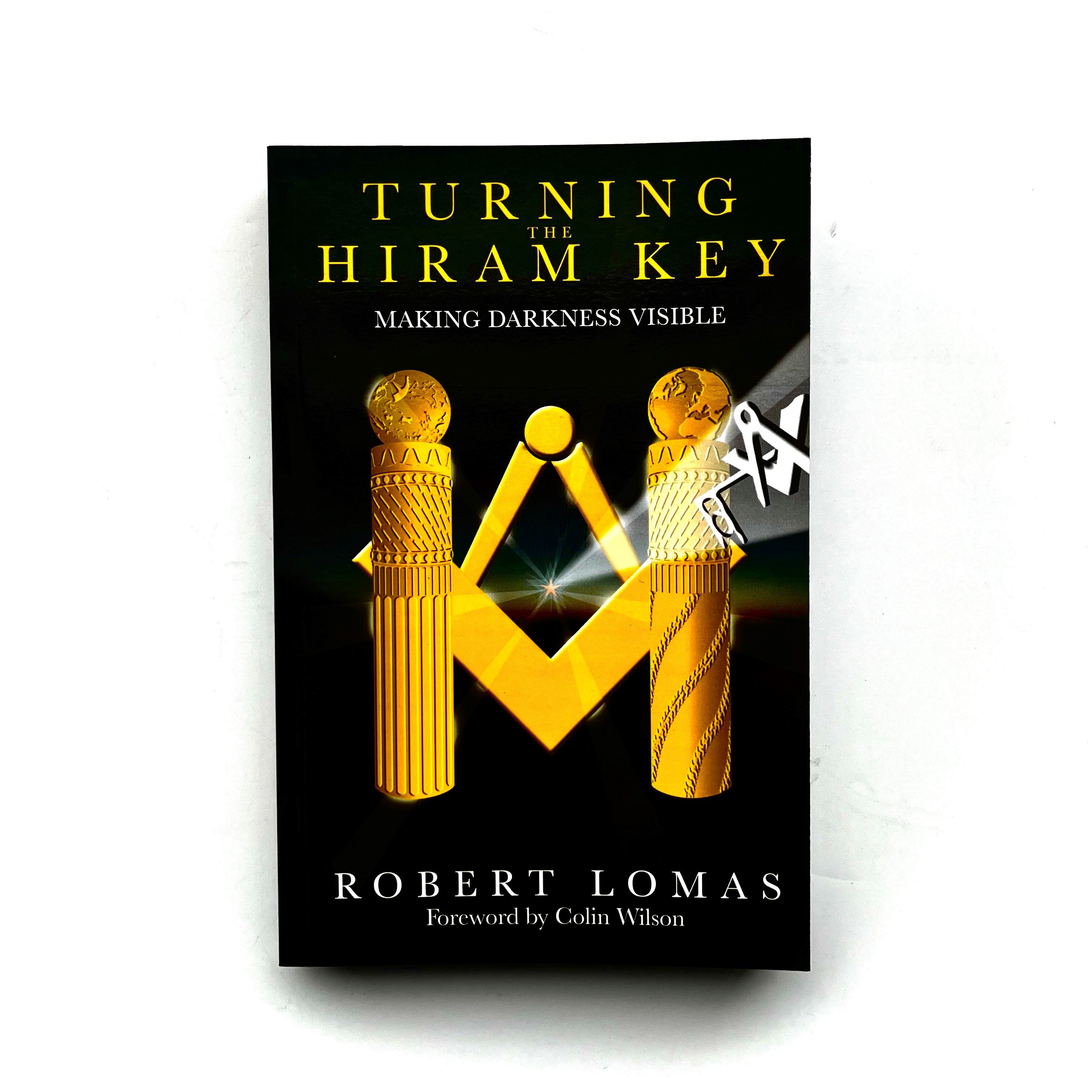 This image features the cover of the book titled "Turning the Hiram Key" by Robert Lomas. The cover design is elegant and mysterious, displaying a dark, foreboding background with a prominent, golden Masonic emblem and a pair of hands holding a light above it.