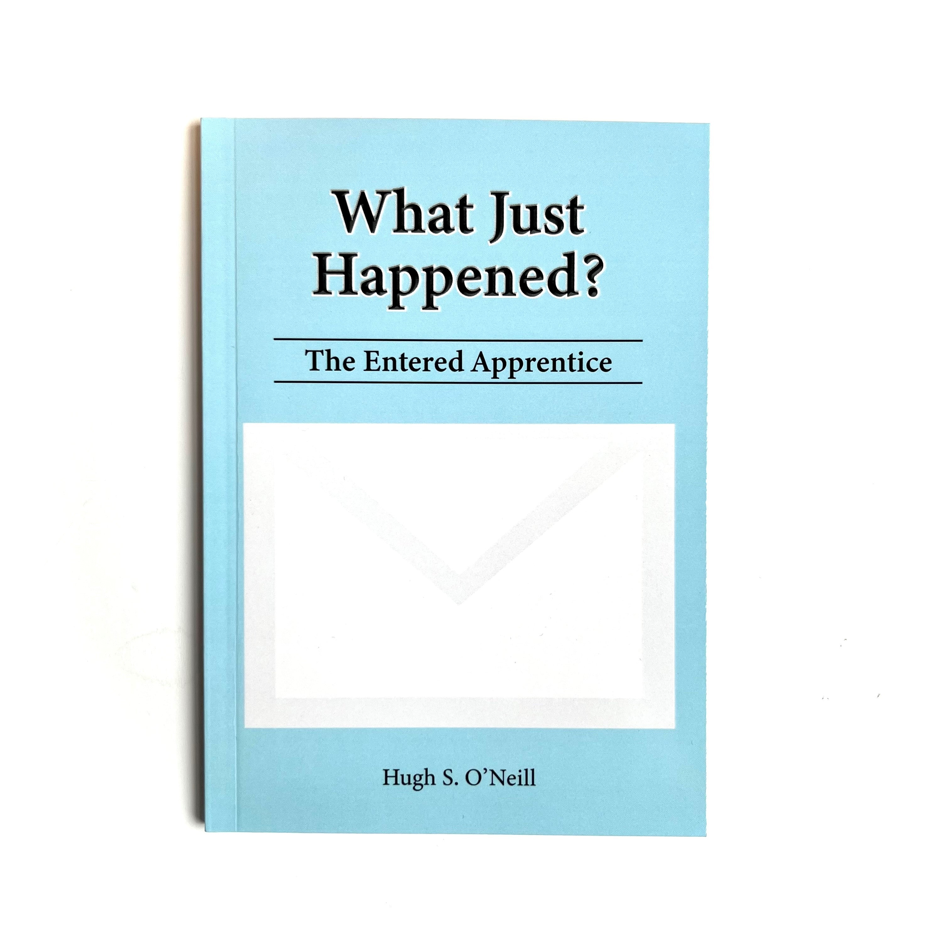 A blue pocket paperback Masonic book titled 'What Just Happened? The Entered Apprentice' by Hugh S. O'Neill.