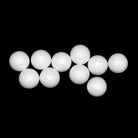 A collection of 10 Masonic Lodge white ballot balls against a black background.