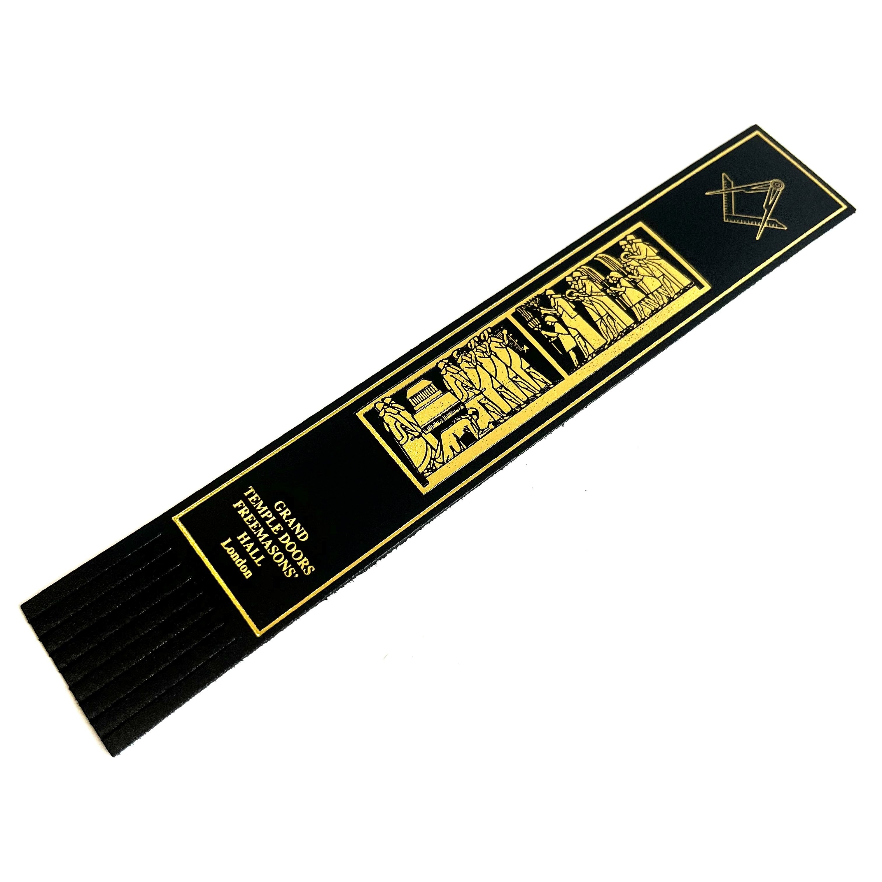 A black leather Masonic bookmark with gold text and emblem detailing.