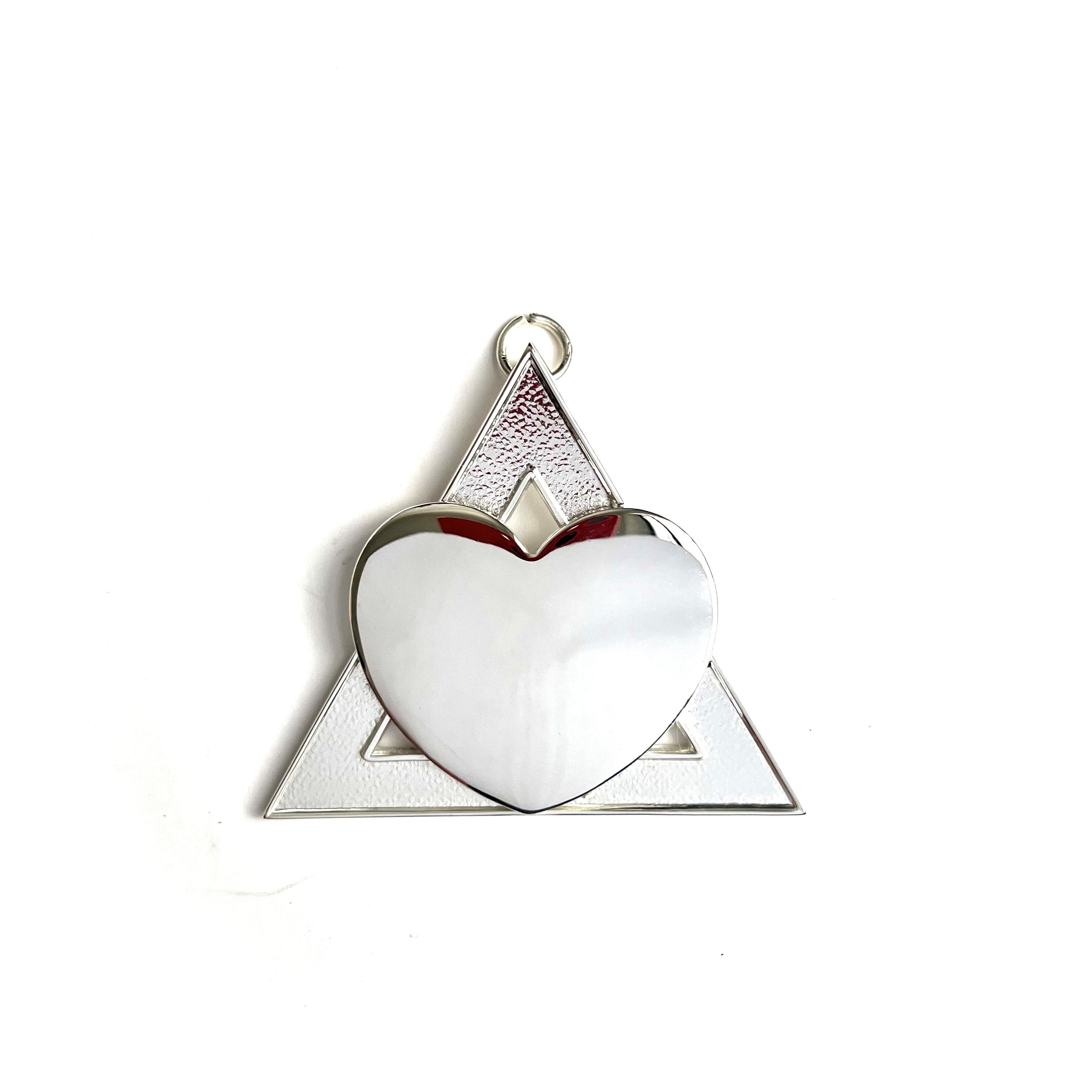 A silver coloured Masonic collar jewel, triangular shaped with a heart in the centre.