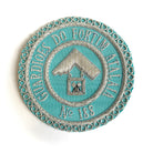 A Craft Light Blue Masonic Apron Badges circular with embroidered text and a symbol in the center, with no visible apron attachment.