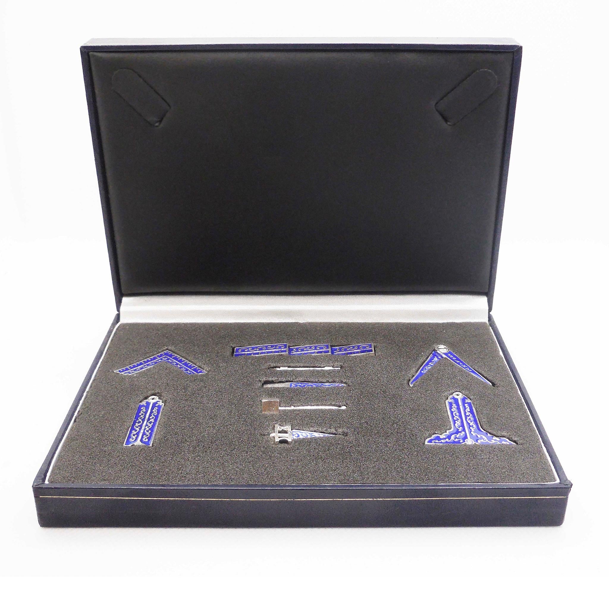 A vbox containing a Masonic tool set with blue enamel accents, displayed on a grey background.