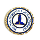 A gold/blue-colored Masonic apron badge with embroidered text and a symbol in the center.