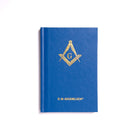 A hardback book with a blue cover featuring a gold emblem of the Freemasonry symbol.