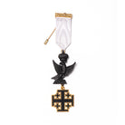 A Masonic Knight of Holy Scepulchure Commander Breast Jewel with a fine white ribbon, black and gold coluored metalworking, featuring a stickpin fitting on the back.