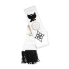 A black & white Masonic sash with black embroidery and a fringe, featuring a bird and geometric patterns.