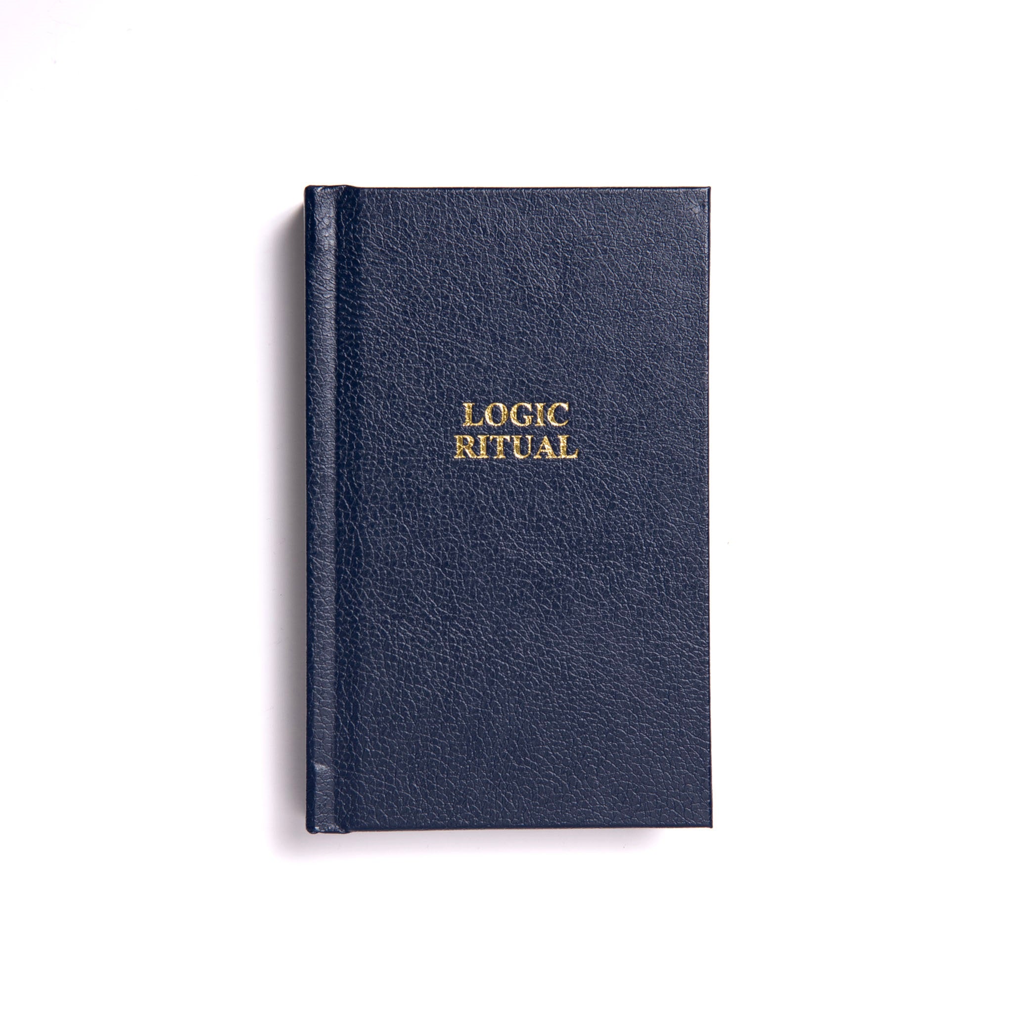 A closed Masonic book with a navy blue cover, titled 'LOGIC RITUAL' in gold lettering.
