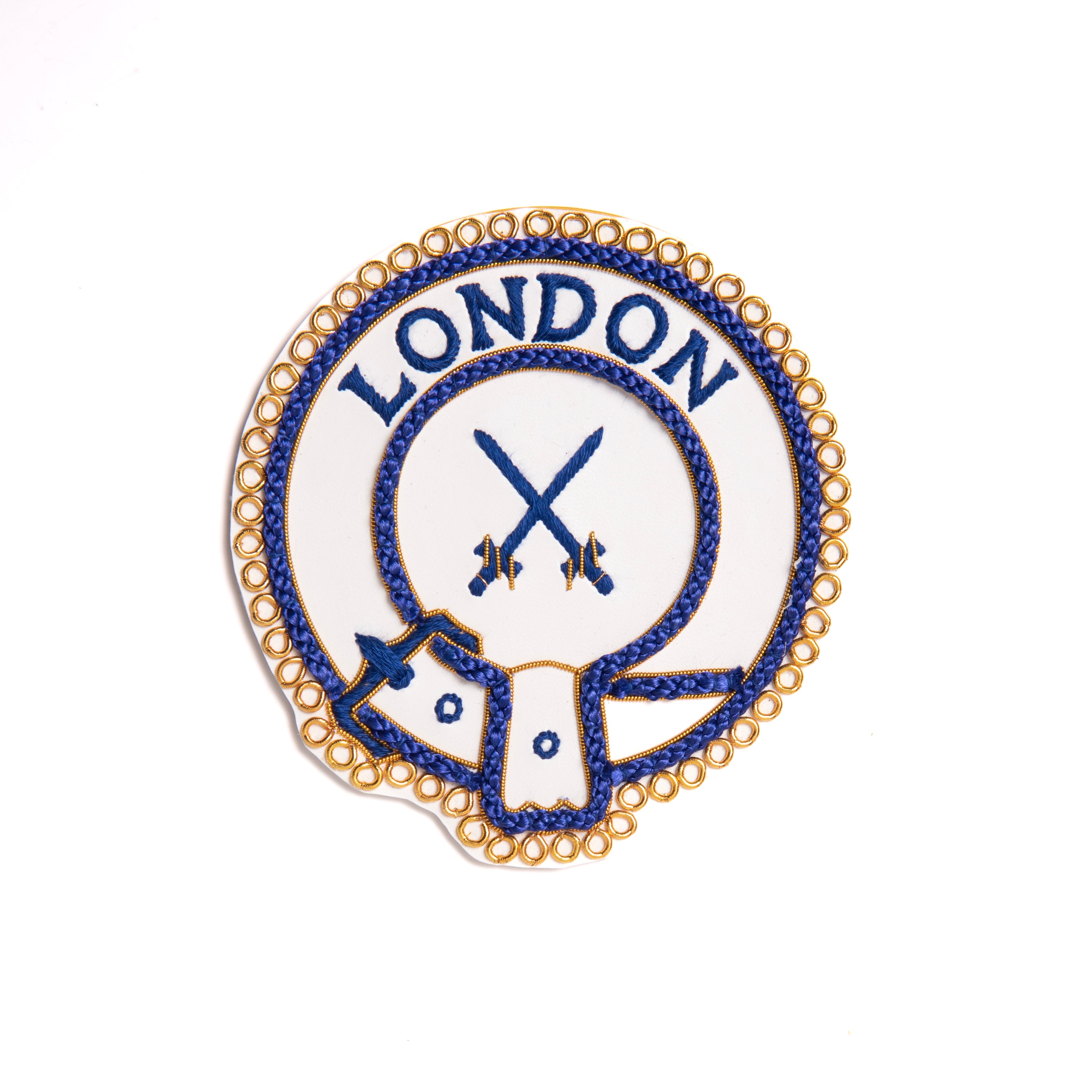 A gold-colored Mark District Undress Apron Badge with the word 'LONDON' and an emblem embroidered on it, without adhesive backing.