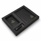 Side view of black leather gift set in a presentation box, including a passport holder,  travel wallet and a luggage tag, each featuring a gold Masonic square-and-compass emblem.