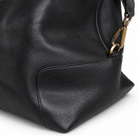 Close-up of black leather Masonic holdall side panel and brass hardware