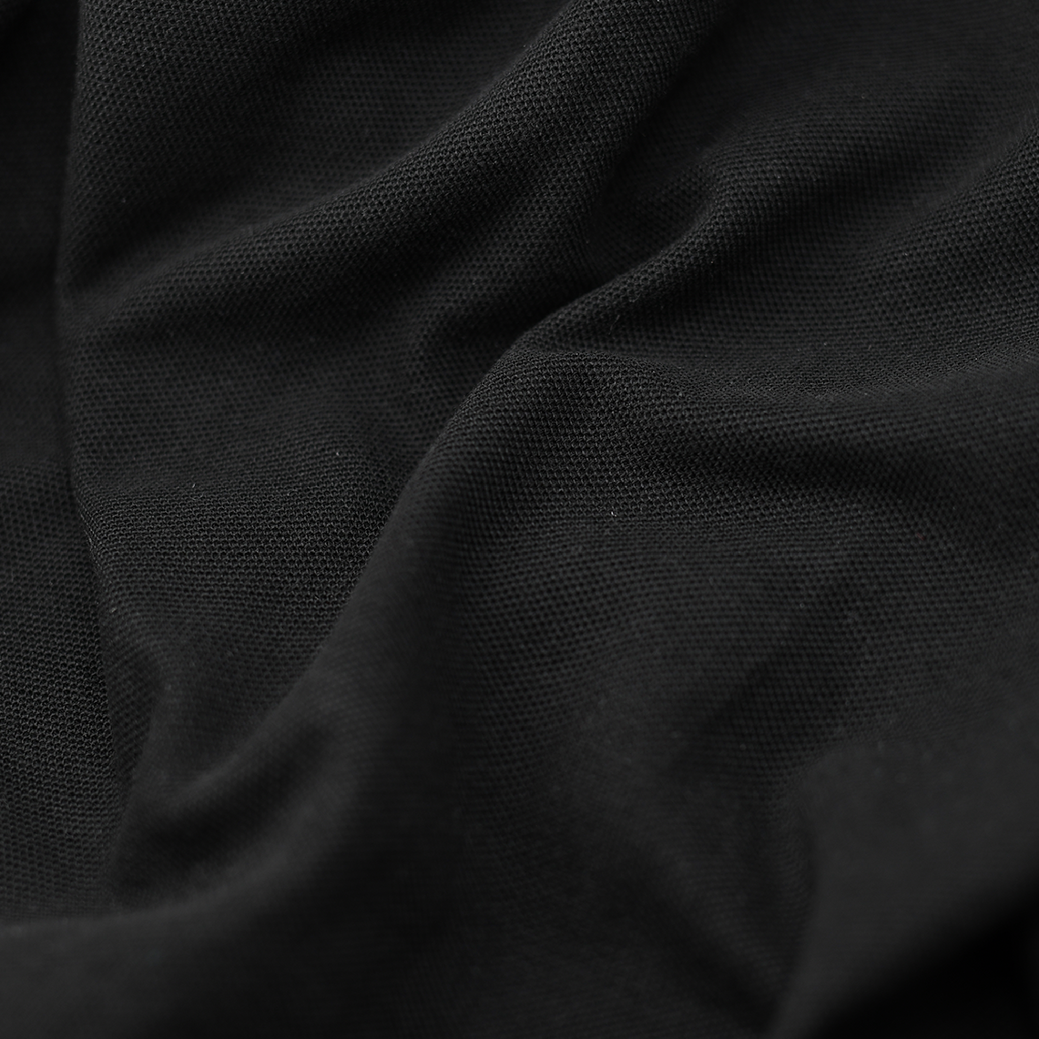 Close up image of black masonic polo shirt fabric.