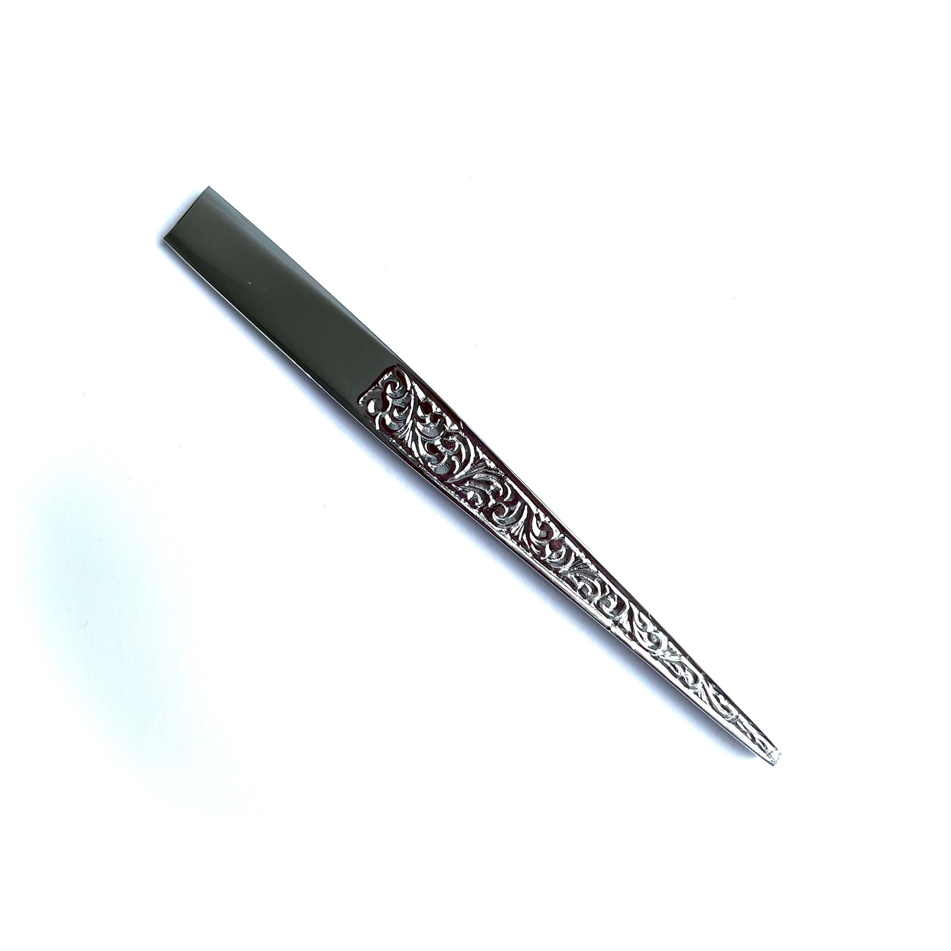 Decorative Masonic Chisel with intricate patterns on a white background