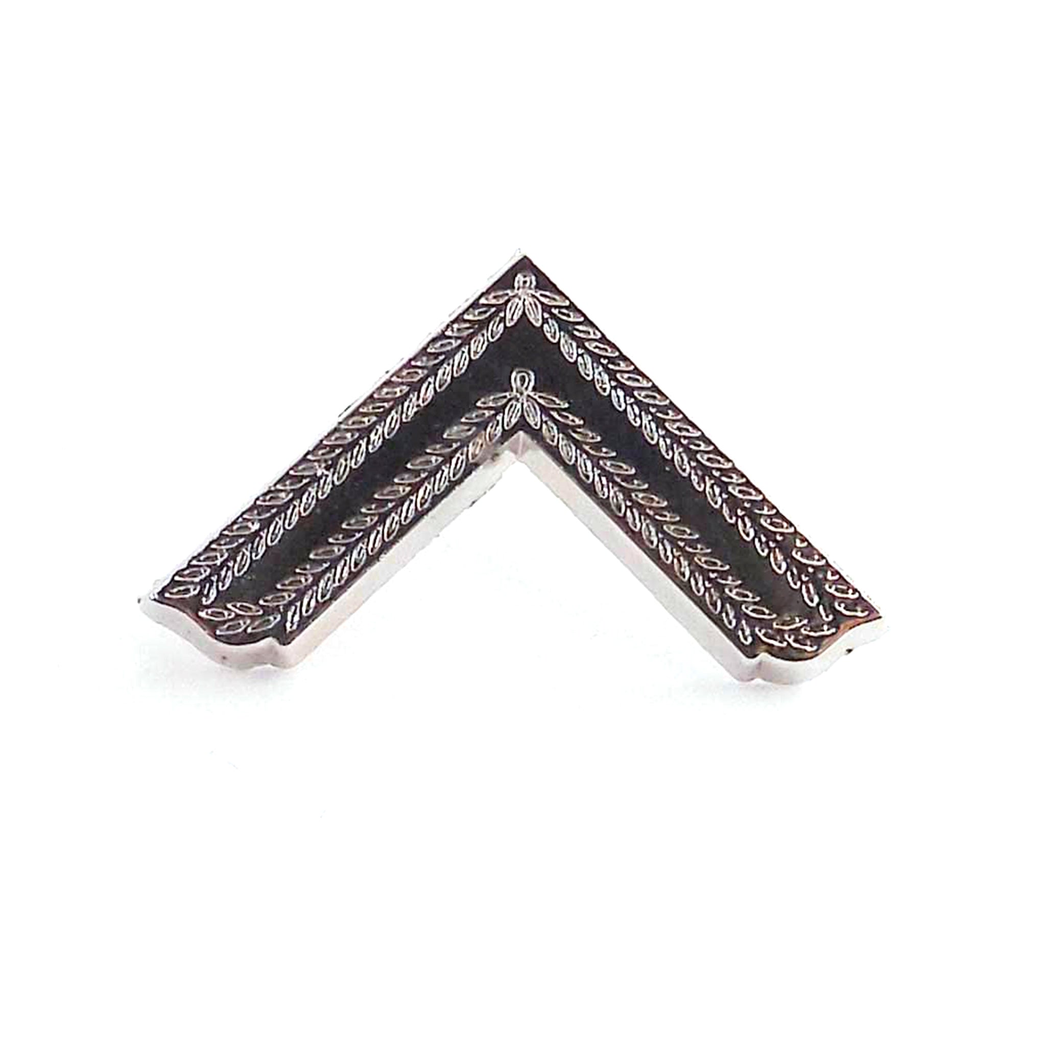 A masonic gold-coloured metal worshipful master lapel pin shaped like a house roof apex with a geometric pattern.
