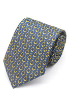 A rolled Masonic Craft polyester tie with a square & compasses pattern in blue and gold colours, laying on a flat surface.