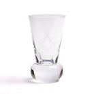 A clear glass with an engraved Masonic square and compasses symbol on the side, standing on a rounded base.