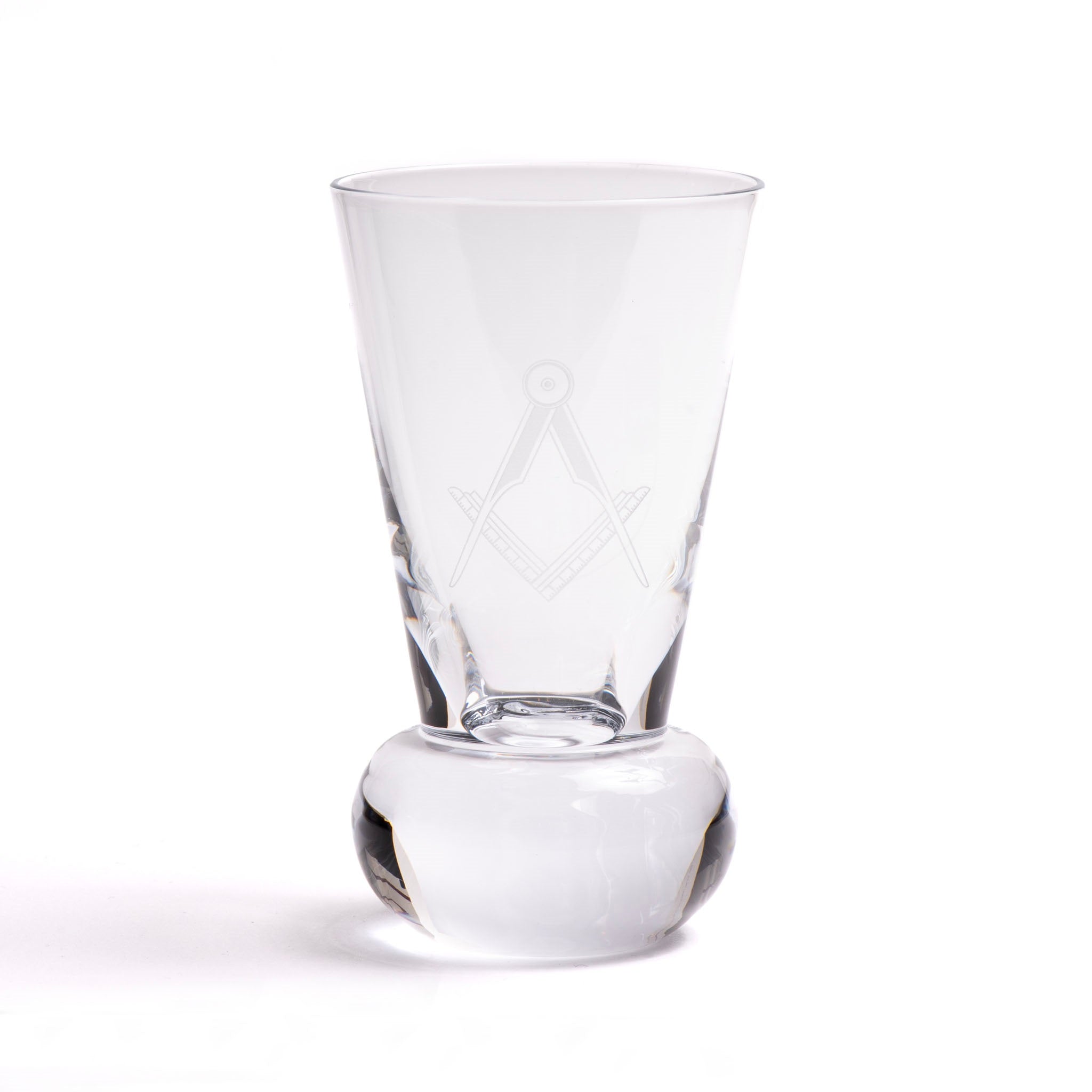 A clear glass with an engraved Masonic square and compasses symbol on the side, standing on a rounded base.