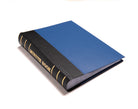 A bound Masonic minute book with a blue and black cover, the title 'MINUTE BOOK' is visible on the spine.