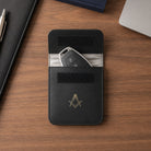 Black leather masonic car key holder on wooden desk
