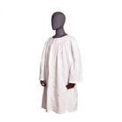A mannequin wearing a plain white surplice designed for ceremonial wear.