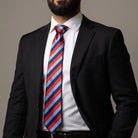 One Journey Masonic tie with a striped light blue, dark blue, and red diagonal rectangle pattern being worn.