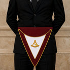 Past Thrice Illustrious Masters Masonic apron with burgundy trim and gold embroidered emblem being worn.