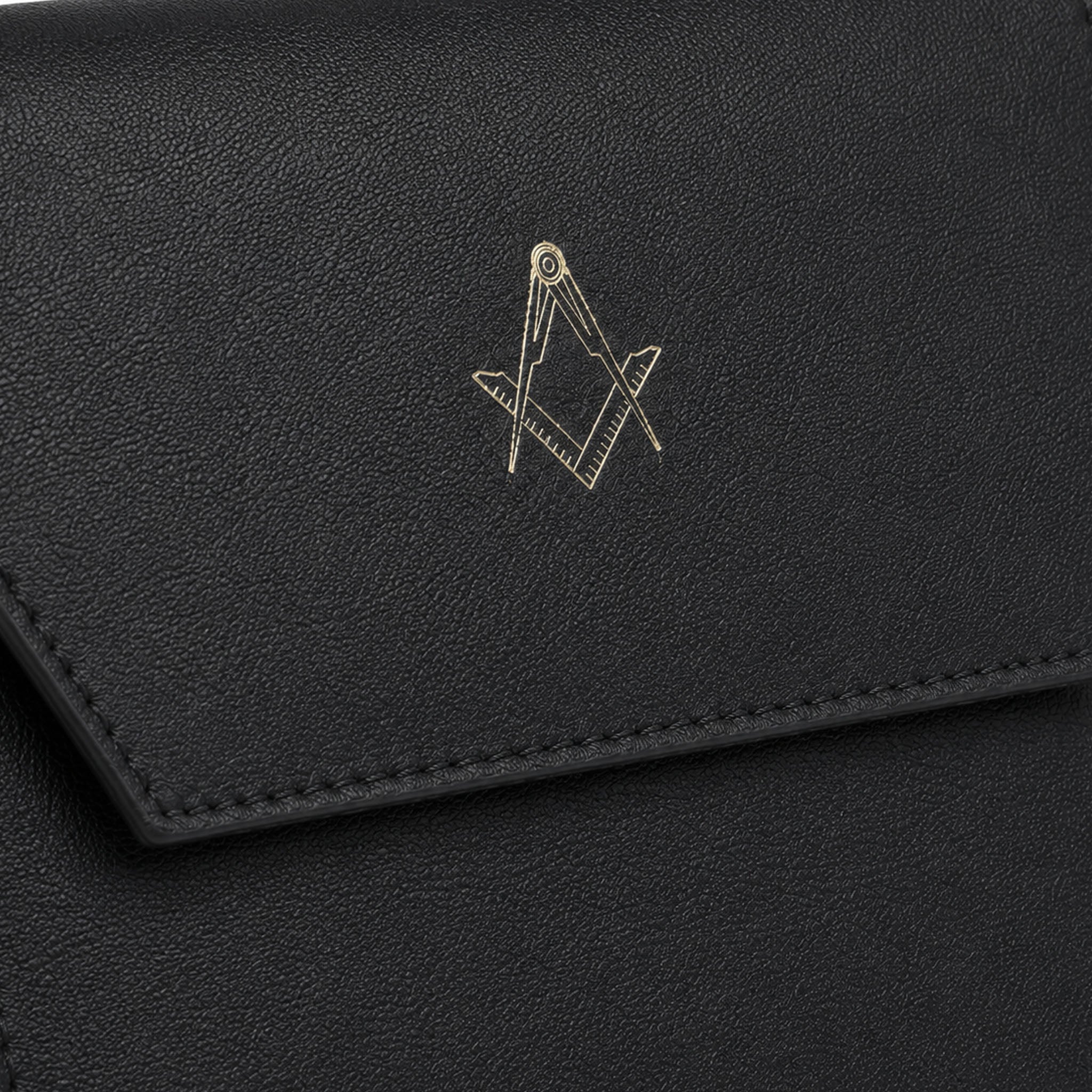Close-up of gold Square and Compasses emblem on black leather masonic jewel holder
