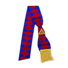 A Masonic Royal Arch sash with blue and red geometric patterns, gold tassels, and a blue triangular badge with a yellow emblem.
