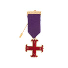 A Red Cross of Constantine Masonic breast jewel with a purple ribbon, gold-colored metalwork, and a red cross pendant.