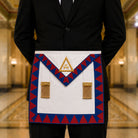 UGLE-approved Masonic Royal Arch Companion apron featuring a white front with a gold emblem, red and blue geometric patterns on the sides being worn.