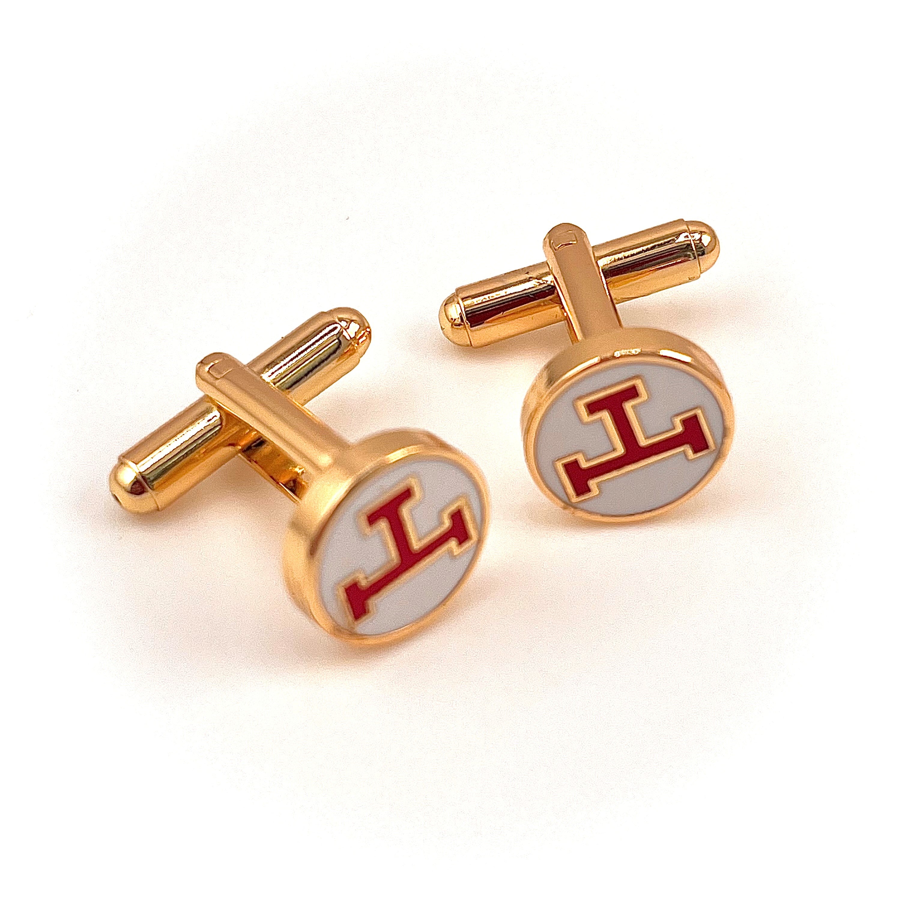 Gold cufflinks with red Royal Arch triple tau logo on a white background