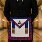 UGLE-approved Masonic Royal Arch Provincial apron featuring a white and blue front with a gold emblem, red and blue geometric patterns on the sides being worn.
