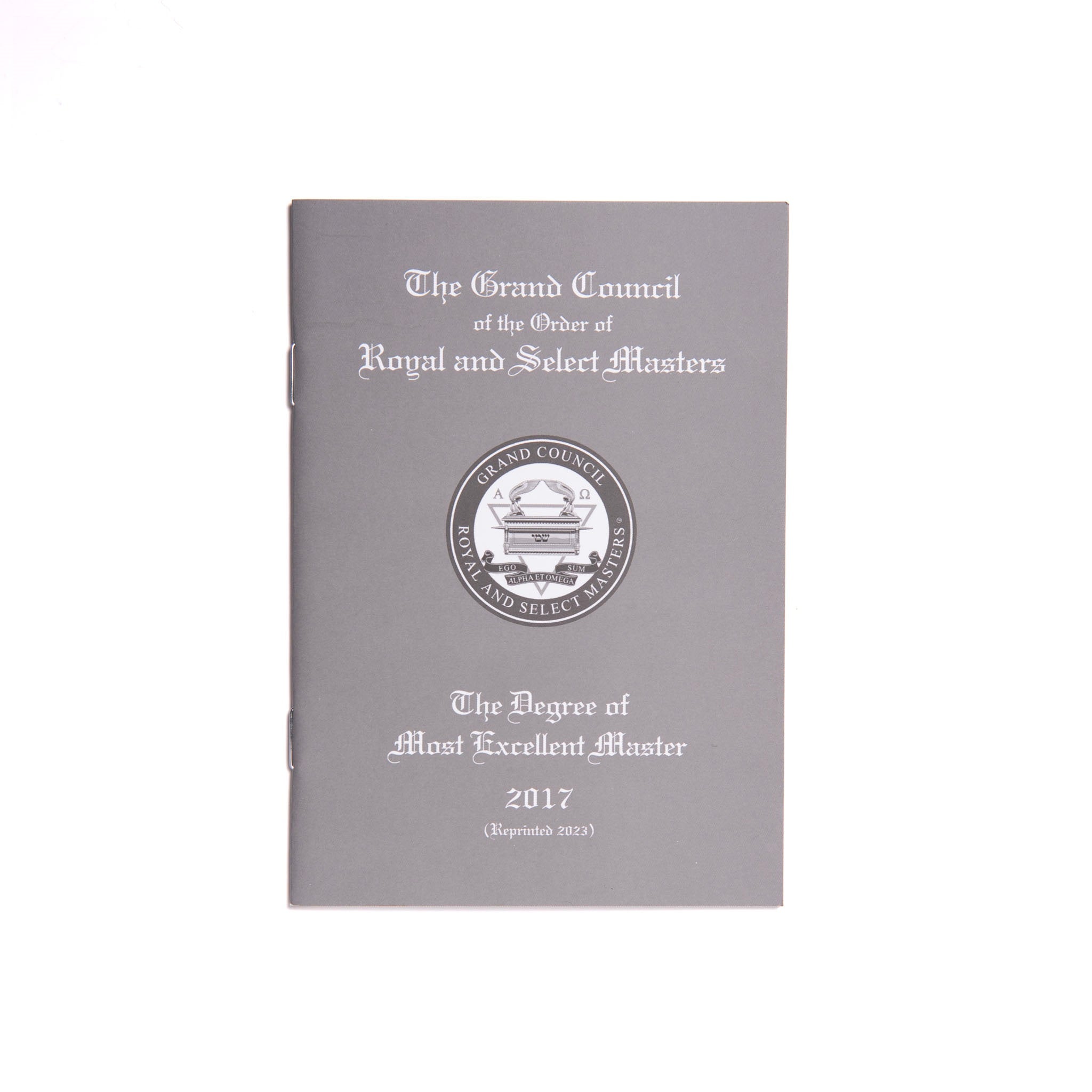 A Masonic book with a grey cover featuring the title 'The Grand Council' and 'The Degree of Most Excellent Master' along with a seal emblem.