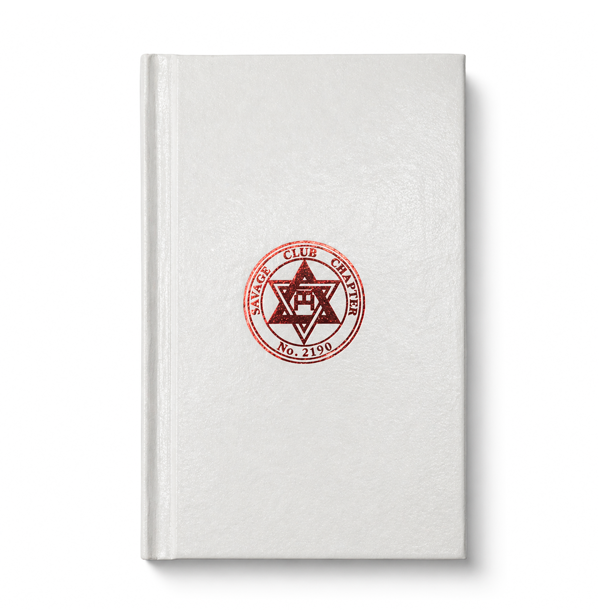 A Masonic Savage Club Royal Arch Ritual closed book with a plain beige cover, featuring a centered emblem or seal on the front.