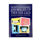 The cover of the book 'Secret Handshakes and Rolled-Up Trouser Legs' featuring cartoon illustrations related to Freemasonry, by Richard Gan