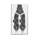 A pair of black square and compasses patterned braces displayed on a card with a patterned background.